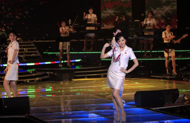 In this Friday, March 28, 2014 photo, singers of the Moranbong Band, Jong Su Hyang, foreground, and  Pak Mi Kyong, left perform on their stage in Pyongyang, North Korea. Step aside, Sea of Blood Opera. North Korean leader Kim Jong Un's favorite guitar-slinging, miniskirt-sporting girl group, the Moranbong Band, is back. And these ladies know how to shimmy. (Photo by Jon Chol Jin/AP Photo)