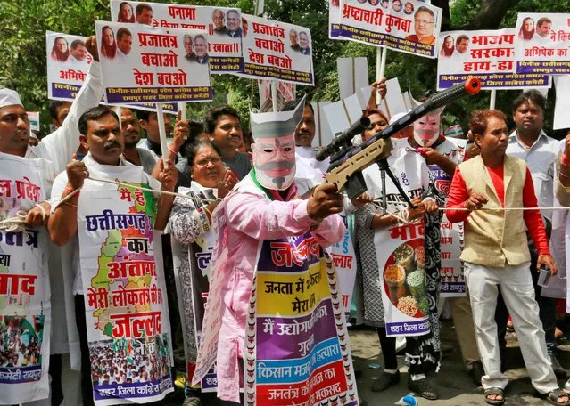 A supporter of India's main opposition Congress party holds a toy rifle as he takes part in what the party calls as a “Save Democracy” march to parliament in New Delhi, India, May 6, 2016. (Photo by Altaf Hussain/Reuters)