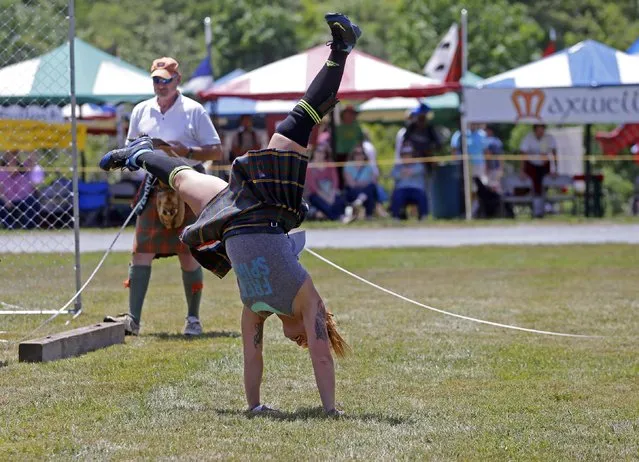 Amanda Ford, of Wilmington, N.C., performs a cartwheel after winning the hammer throw during the 59th annual Grandfather Mountain Highland Games in Linville, N.C., Friday, July 10, 2015. (Photo by Chuck Burton/AP Photo)
