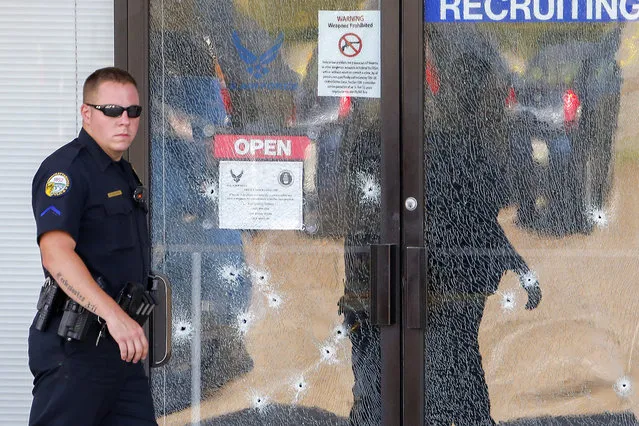 A Chattanooga Police officer walks past the bullet-riddled front door of a US Military Recruiting storefront after a shooting in Chattanooga, Tennessee, USA, 16 July 2015. Authorities say the shootings at two different locations left four US Marines and the gunman Mohammod Youssuf Abdulazeez dead. (Photo by Erik S. Lesser/EPA)