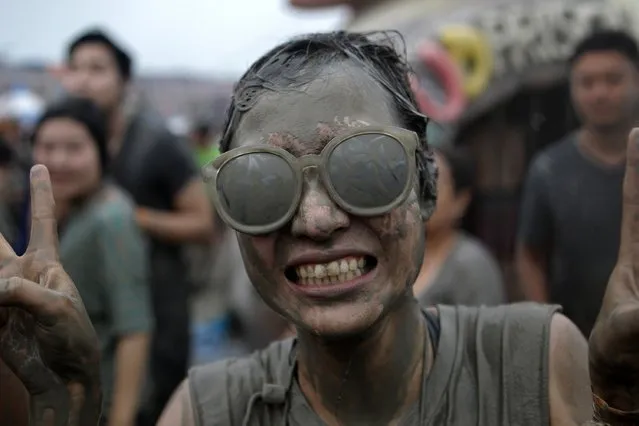 Festival-goers enjoy the mud during the annual Boryeong Mud Festival at Daecheon Beach on July 18, 2015 in Boryeong, South Korea. (Photo by Chung Sung-Jun/Getty Images)