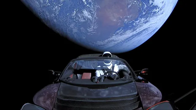 A cherry red Tesla Roadster automobile floats through space after it was carried there by SpaceX's Falcon Heavy in this image obtained by Reuters on February 9, 2018. (Photo by SpaceX/Handout via Reuters)