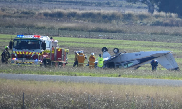 Emergency services respond to a plane crash at Cowra airport, on the New South Wales central tablelands in Cowra, Australia on April 11, 2024. The plane, which was believed to have had two occupants, is suspected to have flipped during takeoff. Neither occupant was injured. (Photo by Cara Kemp/Cowra Guardian)