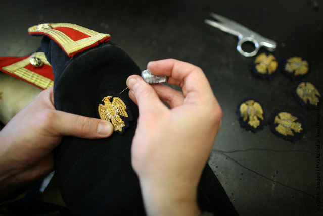 Trooper Gary Shaw of The Household Cavalry Mounted Regiment (HCMR) sews a Napoleonic eagle badge to a Blues and Royals tunic in the Tailor Shop at Hyde Park Barracks