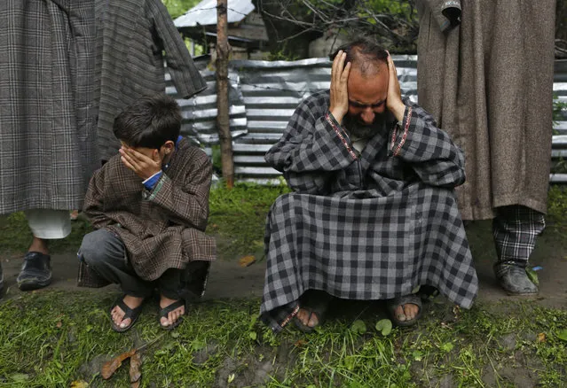 Kashmiri relatives cry during the funeral of civilian Adil Magray at Shopian, about 60 kilometers (38 miles) south of Srinagar, Indian controlled Kashmir, Wednesday, June 7, 2017. Magray, was killed on Tuesday after government forces opened fire on protesters during a search operation to flush out Kashmiri rebels in the southern town of Indian controlled Kashmir, police said. (Photo by Mukhtar Khan/AP Photo)