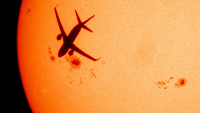 Massive sunspot AR3780 (left of centre) comes into view as a passing high altitude airliner passes in front in London on August 7, 2024. Sunspots became visible on Wednesday – the rare phenomena are cooler parts of the sun’s surface caused by big changes in its magnetic field. (Photo by Malcolm Park/Alamy Live News)