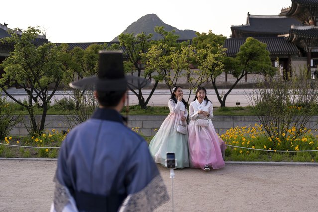 Two women dressed in traditional hanbok laugh as they pose for photos at Gyeongbok Palace, the main royal palace during the Joseon Dynasty, in Seoul, Thursday, May 23, 2024. (Photo by Jae C. Hong/AP Photo)