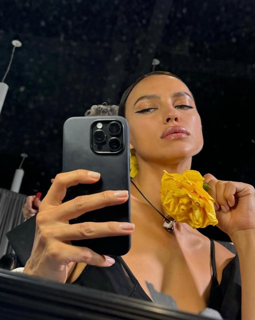 Russian fashion model Irina Shayk poses with a yellow flower on September 11, 2024. (Photo by irinashayk/Instagram)