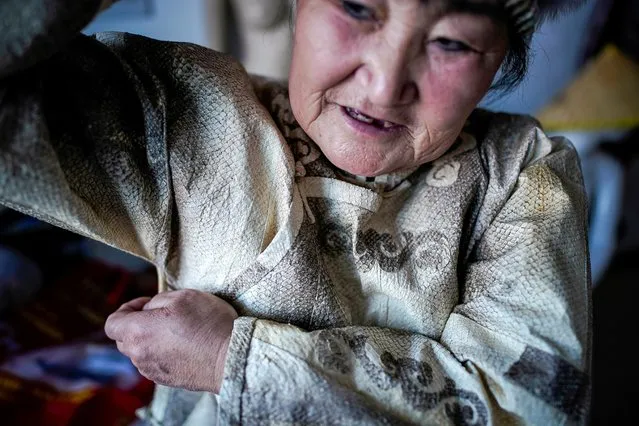 You Wenfeng, 68, poses with her fishskin clothes at her studio in Tongjiang, Heilongjiang province, China December 31, 2019. You, who belongs to China's tiny Hezhen ethnic group, is one of the few people in her community who can still make clothing from the skin of fish. (Photo by Aly Song/Reuters)