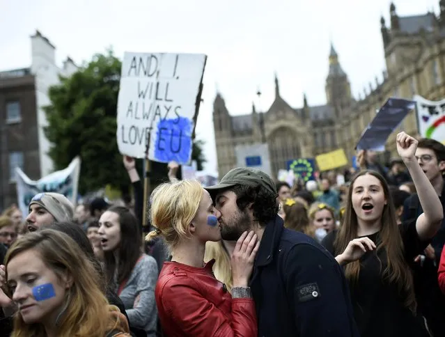 A couple kiss outside the Houses of Parliament during a protest aimed at showing London's solidarity with the European Union following the recent EU referendum, in central London, Britain June 28, 2016. (Photo by Dylan Martinez/Reuters)