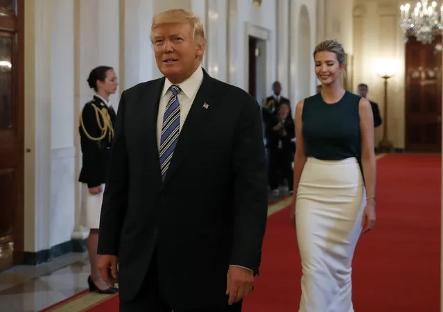 President Donald Trump, followed by his daughter Ivanka Trump, walks to the East Room of the White House in Washington, Tuesday, August 1, 2017, to speak with small business owners as part of “American Dream Week”. (Photo by Alex Brandon/AP Photo)