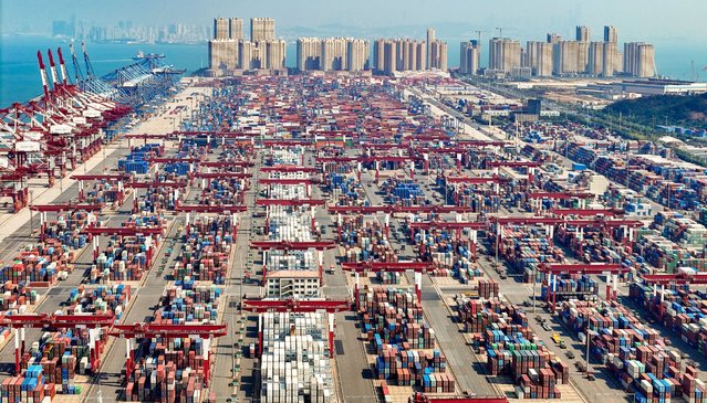 Cargo ships load and unload containers in the Qingdao area of the China (Shandong) Pilot Free Trade Zone in Qingdao, China, on October 8, 2024. (Photo by Costfoto/NurPhoto/Rex Features/Shutterstock)