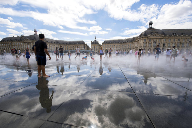 People refresh themselves in the Water Mirror fountain in the center of Bordeaux, France, 04 August 2017. Southern Europe and Balkans are experiencing a heatwave with temparatures reaching more than 40 degrees Celsius. (Photo by Caroline Blumberg/EPA)