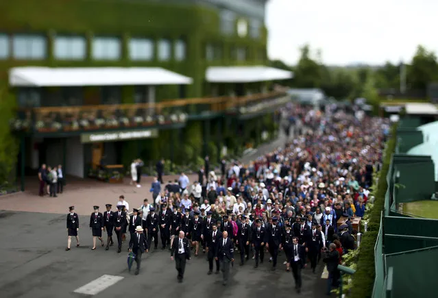 Spectators are led into the Wimbledon grounds by security ahead of the start of day four of the tennis tournament in London, England on July 1, 2016. Wimbledon attendance hit a nine-year low in its opening week as miserable weather deterred ticket holders from turning up. The first four days of the tournament were attended by 155,845 tennis fans – the lowest turnout since 2007, when 148,986 attended. (Photo by Jordan Mansfield/Getty Images)