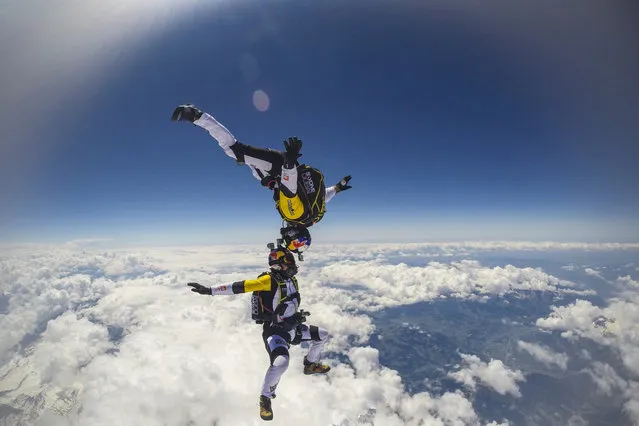 Fred Fugen and Vincent Reffet seen jumping at 33,000 feet (10 km) above the Mont Blanc, French Alps on May 31, 2014. Fearless skydivers jump from an altitude of 10,000 meters above the largest mountain in Europe. Frederic Fugen, 34, and Vincent Reffet, 29, leapt from a plane in the freezing skies above Mont-Blanc in the French Alps. (Photo by Dominique Daher/Barcroft Media)