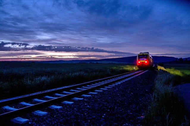 A regional train approaches the city of Wehrheim near Frankfurt, Germany, Monday, May. 23, 2022. With special 9-euro monthly tickets that are available from Monday on, people will be able to board buses and trains all over the country in June, July and August in Germany. (Photo by Michael Probst/AP Photo)