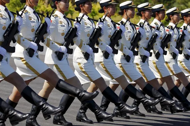 Soldiers of China's People's Liberation Army march with their weapons during a training session for a military parade to mark the 70th anniversary of the end of World War Two, at a military base in Beijing, China, August 22, 2015. (Photo by Damir Sagolj/Reuters)