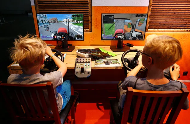 Children play video games at the world's largest computer games fair, Gamescom, in Cologne, Germany August 23, 2017. (Photo by Wolfgang Rattay/Reuters)