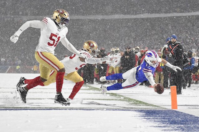 Buffalo Bills quarterback Josh Allen, foreground right, dives toward the end zone to score past San Francisco 49ers defensive end Robert Beal Jr. (51) and linebacker Dee Winters during the second half of an NFL football game in Orchard Park, N.Y., Sunday, December 1, 2024. (Photo by Adrian Kraus/AP Photo)