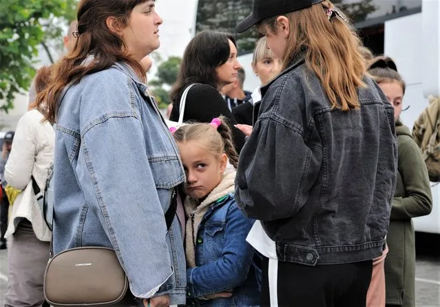 Ukrainian children say goodbye to relatives before boarding buses for their trip to France, in Lviv, Ukraine, 12 August 2022. About 70 children of Ukrainian defenders and internally displaced people (IDPs) departed to France for summer rest at the expense of the host while the Russian military invasion is ongoing. Russian troops on 24 February entered Ukrainian territory, starting a conflict that has provoked destruction and a humanitarian crisis. (Photo by Mykola Tys/EPA/EFE)