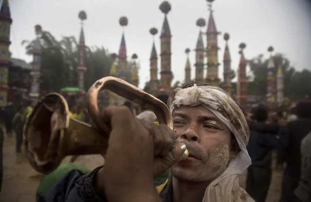 An Indian Pnar or Jaintia tribal man blows a bugle during Behdienkhlam festival celebrations at Tuber village, in the northeastern Indian state of Meghalaya, India, Thursday, July 21, 2016. (Photo by Anupam Nath/AP Photo)