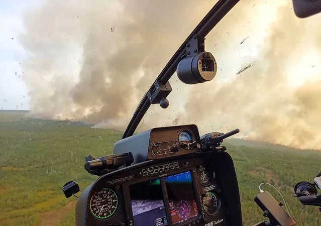 This handout picture released by Greenpeace Russia on August 18, 2022, shows a wildfire from a helicopter in Ryazan region outside Moscow. (Photo by Handout/Greenpeace Russia via AFP Photo)