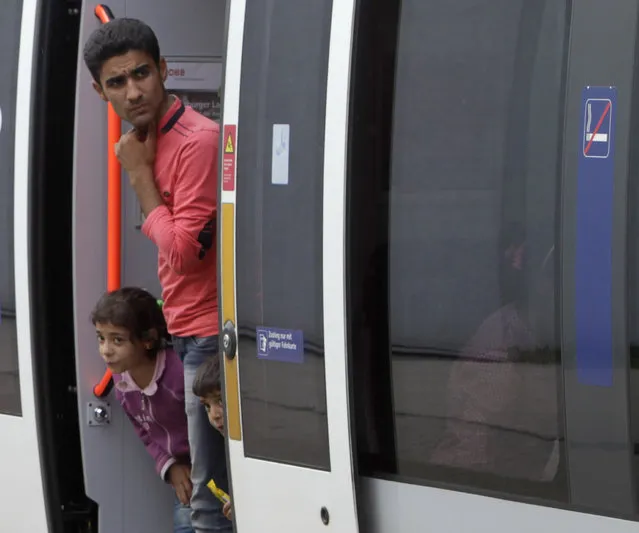 Migrants look out from a train at the railway station in Nickelsdorf, Austria September 5, 2015. (Photo by Srdjan Zivulovic/Reuters)