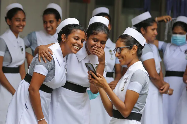 Group of Sri Lankan nurses engage in taking selfies after the International Nurses Day celebration at the Infectious Diseases Hospital (IDH) in Colombo, Sri Lanka,12 May 2020. The infectious disease hospital (IDH) is the main hospital in Sri Lanka to treat patients who are positive for coronavirus. International Nurses Day is marked annually to commemorate the birth anniversary of British nurse Florence Nightingale on 12 May 1820, who was the founder of modern nursing. (Photo by Chamila Karunarathne/EPA/EFE)