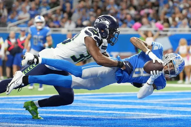 Josh Reynolds #8 of the Detroit Lions scores a touchdown against Mike Jackson #30 of the Seattle Seahawks during the fourth quarter of the game at Ford Field on October 02, 2022 in Detroit, Michigan. (Photo by Nic Antaya/Getty Images)