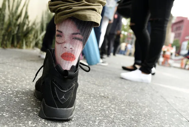 A fan of the late singer Selena Quintanilla wears socks bearing her image before a ceremony to award her a posthumous star on the Hollywood Walk of Fame on Friday, November 3, 2017, in Los Angeles. (Photo by Chris Pizzello/Invision/AP Photo)