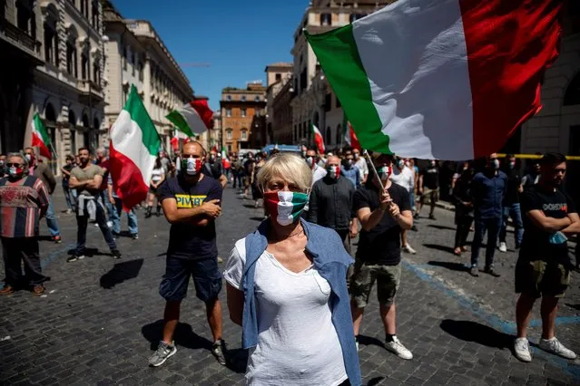 Protesters, wearing protective masks with the Italian tricolor, demonstrate against the Italian Government for the economic problems the country is having due to the coronavirus pandemic as phase three of the lifting lockdown exit plan continues on June 6, 2020 in Rome, Italy. The protest demonstration against the Italian government was organized by the spontaneous Facebook group “Mascherine Tricolori” (Tricolor masks) to support Italian trade and businesses in serious difficulty due to the Covid pandemic. Many Italian businesses continue to reopen after more than three months of a nationwide lockdown meant to curb the spread of Covid-19. (Photo by Antonio Masiello/Getty Images)