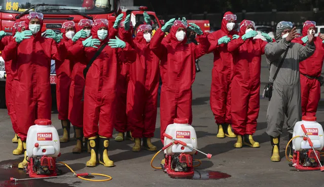 Indonesian fireman prepare for sprays disinfectant in an attempt to help curb the spread of the new coronavirus at Istiqlal Mosque in Jakarta, Indonesia, Wednesday, June 3, 2020. (Photo by Achmad Ibrahim/AP Photo)