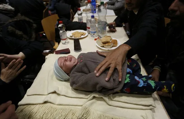 A Syrian mother takes care of her baby at a reception centre after their arrival at the main railway station in Dortmund, Germany September 13, 2015. Germany re-imposed border controls on Sunday after Europe's most powerful nation acknowledged it could scarcely cope with thousands of asylum seekers arriving every day. (Photo by Ina Fassbender/Reuters)