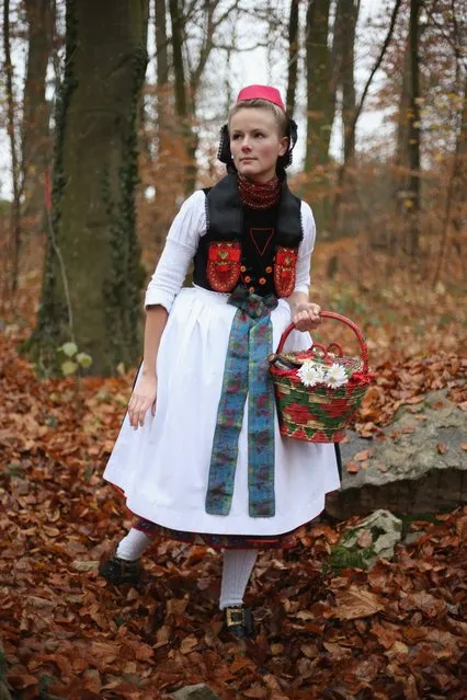 Little Red Riding Hood (in German: Rotkaeppchen, which translates to Little Red Cap), actually actress Dorothee Weppler, wears the local Schwalm region folk dress with its red cap as she walks through a forest on the estate of Baron von Schwaerzel on November 20, 2012 in Willingshausen, Germany. Little Red Riding Hood is one of the many stories featured in the collection of fairy tales collected by the Grimm brothers, and the two reportedly first came across the story while staying on the von Schwaerzel estate. The 200th anniversary of the first publication of Grimms' Fairy Tales will take place this coming December 20th. The Grimm brothers collected their stories from oral traditions in the region between Frankfurt and Bremen in the early 19th century, and the works include such global classics as Sleeping Beauty, Rapunzel, The Pied Piper of Hamelin, Cinderella and Hansel and Gretel.  (Photo by Sean Gallup)