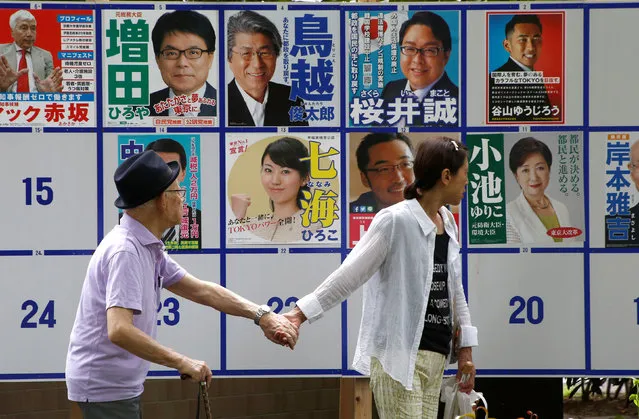 People walk past candidate posters for the Tokyo Governor election in Tokyo, Japan, July 31, 2016. (Photo by Kim Kyung-Hoon/Reuters)