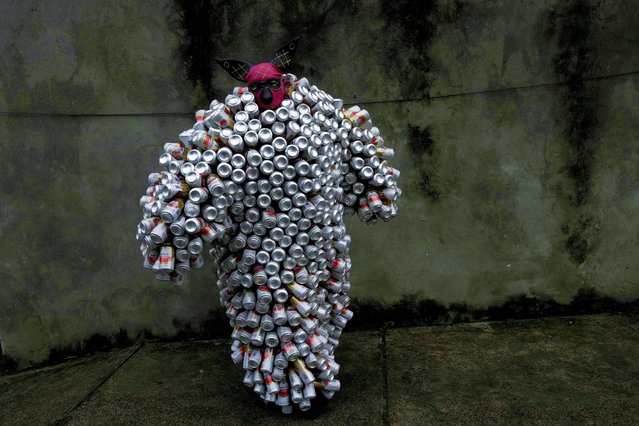 A reveler wearing a costume made from beer and soda cans takes part in the “Bloco da Latinha” street party Carnival parade in Madre de Deus, Brazil, Sunday, February 11, 2024. (Photo by Eraldo Peres/AP Photo)