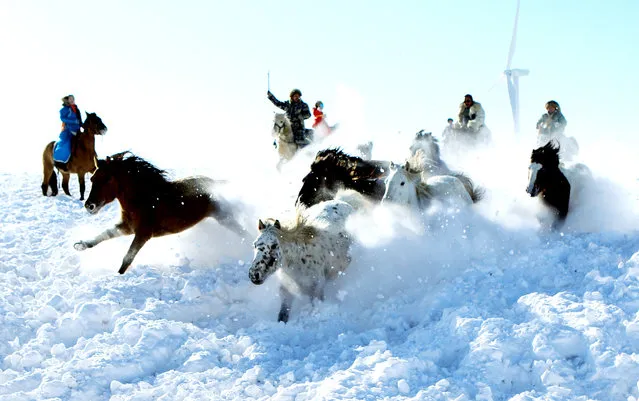 Herdsmen tame horses on the snow-covered grassland on December 26, 2017 in Xilingol League, Inner Mongolia Autonomous Region of China. Xilingol herdsmen tame horses and welcome tourists in winter. (Photo by VCG/VCG via Getty Images)