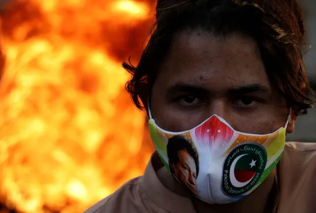 Supporters of former Prime Minister Imran Khan shout slogans during a protest following the attack on Khan, in Rawalpindi, Pakistan, 07 November 2022. Khan suffered a gunshot wound on 03 November after an unidentified attacker opened fire on a crowded rally led by the politician in Wazirabad, officials said. The former prime minister was leading a long march from Lahore to the capital Islamabad to pressure the government for early elections in the country. (Photo by Sohail Shahzad/EPA/EFE)