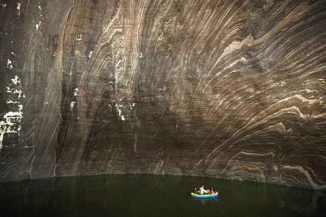 Tourists ride in boats at an underground lake at the Salina Turda, a former salt mine turned touristic attraction, now listed by emergency authorities as a potential civil defense shelter in Turda, central Romania, Monday, October 17, 2022. Fighting around Ukraine's nuclear power plants and Russia's threats to use nuclear weapons have reawakened nuclear fears in Europe. This is especially felt in countries near Ukraine, like Poland, where the government this month ordered an inventory of the country's shelters as a precaution. (Photo by Vadim Ghirda/AP Photo)