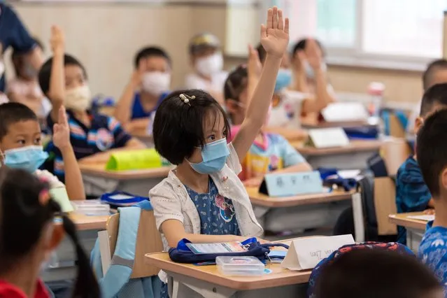 Students wearing face masks have a class at a primary school on the first day of a new semester on September 1, 2020 in Wuhan, Hubei Province of China. (Photo by Splash News and Pictures/China Stringer Network)