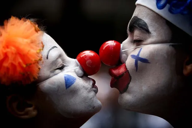 A couple dressed as clowns participate in the “Cordao da Bola Preta” street parade in Rio de Janeiro. (Photo by  Felipe Dana/Associated Press)