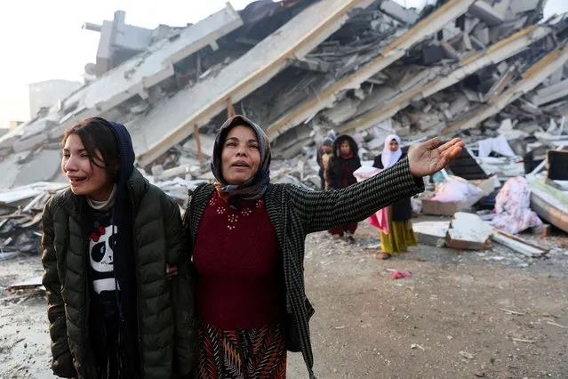 Women react near rubble following an earthquake in Hatay, Turkey on February 7, 2023. (Photo by Umit Bektas/Reuters)