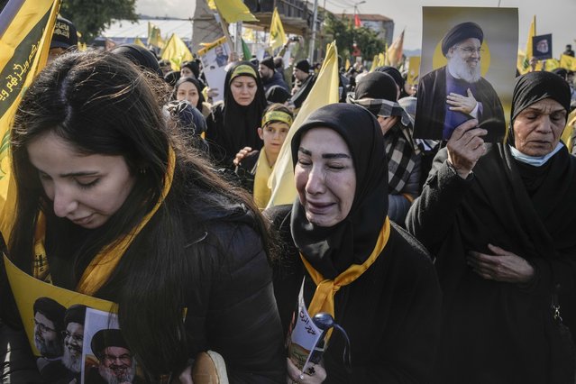 Mourners hold pictures of Hezbollah's former leader Hassan Nasrallah and his cousin and successor Hashem Safieddine as they gather along a highway to attend their funeral procession in Beirut, Lebanon, Sunday February 23, 2025. (Photo by Bilal Hussein/AP Photo)