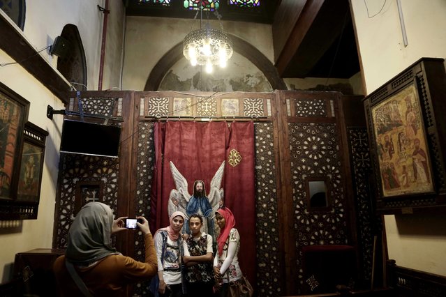Egyptian Muslim girls visit the Hanging Church in Old Cairo, Egypt, Tuesday, August 30, 2016. After long hoping for an end to restrictions on the building of churches, many of Egypt's Christians are infuriated and feeling betrayed after lawmakers on Tuesday passed a law giving authorities broad powers to veto construction for vague reasons including worries over “national security”. (Photo by Nariman El-Mofty/AP Photo)