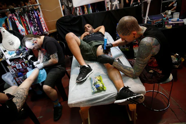 Tattoo artists work during the annual Israel Tattoo Convention in Tel Aviv, Israel, October 8, 2016. (Photo by Baz Ratner/Reuters)