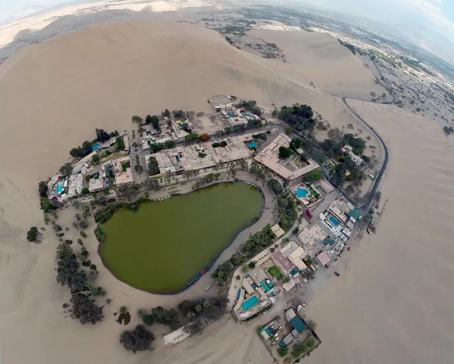 Aerial  view of the Huacachina Oasis in Ica, Peru, some 300 km south of Lima on December 11, 2014, one of Ica's main attractions, located just 5 km from the departamental capital. (Photo by Martin Bernetti/AFP Photo)