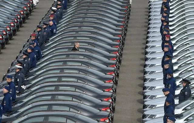 Hungarian Minister of Interior Sandor Pinter (C) passes between rows of new patrol cars of the Hungarian police force, at the yard of the operational police headquarters during the official handover ceremony in Budapest, Hungary, 23 March 2018. The police department acquired a total of 570 vehicles. Pinter pointed out in his inauguration speech that the number of criminal offences have decreased from 430 thousand in 2010 to 215 thousand in 2017 in the country. (Photo by Zoltan Mathe/EPA/EFE)