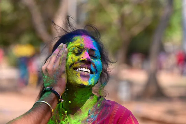 A woman smeared with “Gulal” or coloured powder during celebrations of Hindu spring festival “Holi” in Hyderabad on March 7, 2023. (Photo by Noah Seelam/AFP Photo)