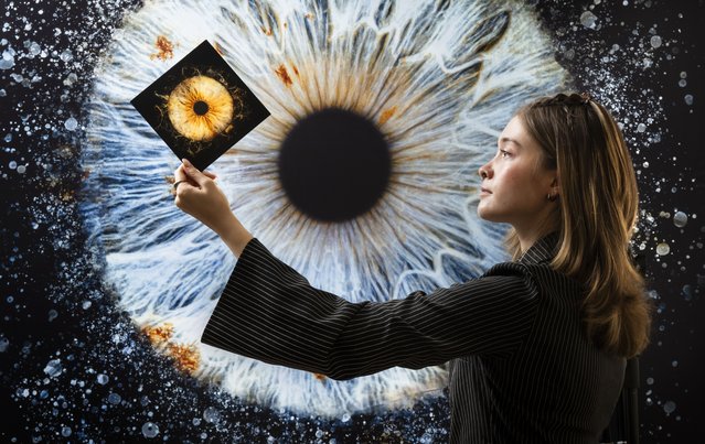 Manager Lucy Hinson with highly detailed photographs of two eyes, created by Iris Galerie in York, UK on Tuesday, September 9, 2025. The company uses state-of-the-art technology to capture every nuance of a client's iris to produce high-resolution personalised wall art. (Photo by Danny Lawson/PA Wire)
