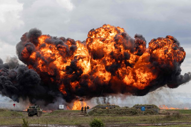 A cloud of smoke and fire rises over the field during  military exercises of Poland and NATO allied countries in Orzysz on September 17, 2025. (Photo by Wojtek Radwanski/AFP Photo)